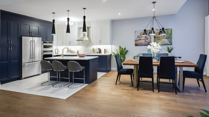 Open-concept kitchen and dining areas complete with marble and hardwood flooring, marble backsplash, stainless steel appliances, quartz countertops, and a chic interior design.
